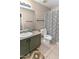 Bathroom showcasing a vanity, toilet, and a shower with striped curtain for a modern touch at 10702 W Orangewood Ave, Glendale, AZ 85307