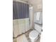 Cozy bathroom featuring a shower/tub combo, neutral colored walls, and wood-look flooring at 10702 W Orangewood Ave, Glendale, AZ 85307