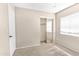 Bedroom featuring a sliding-door closet, carpet floors, and a window for natural light at 10702 W Orangewood Ave, Glendale, AZ 85307