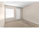 Cozy bedroom with neutral carpet, a window with blinds, and a standard closet door at 10702 W Orangewood Ave, Glendale, AZ 85307