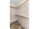 Walk-in closet with shelving and wood-look flooring, providing ample storage space at 10702 W Orangewood Ave, Glendale, AZ 85307