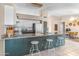 Bright kitchen featuring granite counters, white cabinets, and a breakfast bar with seating for three at 10702 W Orangewood Ave, Glendale, AZ 85307
