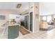 Open kitchen with white cabinets, stainless steel appliances, and a view into the living area at 10702 W Orangewood Ave, Glendale, AZ 85307