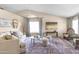 Bright living room with vaulted ceilings, plush seating, and natural light at 10702 W Orangewood Ave, Glendale, AZ 85307