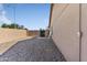 Spacious side yard features gravel, block wall fencing, and a storage shed at 10702 W Orangewood Ave, Glendale, AZ 85307