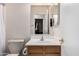 Well-lit bathroom featuring a vanity with a sink, a toilet, and a mirror providing a functional space at 11206 W Coronado Rd, Avondale, AZ 85392