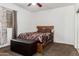 Cozy bedroom with a comfortable bed, soft carpet, a wooden headboard, and natural light from a window at 11206 W Coronado Rd, Avondale, AZ 85392