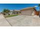 Charming single-Gathering home featuring a two-car garage, manicured lawn, and inviting curb appeal on a sunny day at 11206 W Coronado Rd, Avondale, AZ 85392