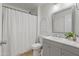 Cozy bathroom featuring a shower with a white curtain and updated vanity at 11550 W Mule Deer Ct, Surprise, AZ 85378