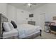 Comfortable bedroom features a ceiling fan, TV, and a charming, rustic-style dresser at 11550 W Mule Deer Ct, Surprise, AZ 85378