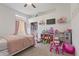 Charming bedroom with a bed, closet, lots of toys, and window at 11550 W Mule Deer Ct, Surprise, AZ 85378