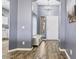 Entryway with bench seating, front door and decorative light fixture at 11550 W Mule Deer Ct, Surprise, AZ 85378
