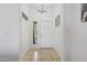 Bright foyer featuring neutral tile flooring, a modern light fixture, and a window for natural light at 11550 W Mule Deer Ct, Surprise, AZ 85378
