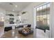 Bright kitchen and dining area with modern appliances, white cabinets, and a view to the backyard at 11550 W Mule Deer Ct, Surprise, AZ 85378