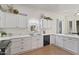 Clean, bright kitchen featuring white cabinets, a black dishwasher, and modern countertops at 11550 W Mule Deer Ct, Surprise, AZ 85378