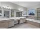 Bathroom with double sinks, vanity, and separate tub and shower, providing a luxurious and functional space at 11717 W Red Hawk Dr, Peoria, AZ 85383