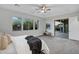Serene bedroom features large windows, a sliding glass door, soft carpet, and a comfortable, inviting king-sized bed at 11717 W Red Hawk Dr, Peoria, AZ 85383