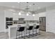 Bright kitchen with stainless steel appliances, a quartz countertop island, and modern pendant lighting at 11717 W Red Hawk Dr, Peoria, AZ 85383