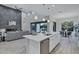 Modern kitchen features a large island, stainless steel appliances, and seamless connection to the living room and dining area at 11717 W Red Hawk Dr, Peoria, AZ 85383