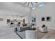 Open-concept living area features high ceilings and flows into the kitchen, enhancing the sense of space and light at 11717 W Red Hawk Dr, Peoria, AZ 85383