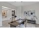 Bright office space with a desk and modern decor, leading to a modern living room at 11717 W Red Hawk Dr, Peoria, AZ 85383