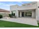 Beautiful backyard patio with sleek architecture, light stone flooring, and a cozy gas fire pit at 11717 W Red Hawk Dr, Peoria, AZ 85383