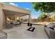 Inviting backyard with a covered patio, outdoor seating, and a modern fire pit feature at 1216 E Rocky Slope Dr, Phoenix, AZ 85048