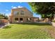 Expansive backyard with lush lawn, a covered patio, and great views of the home's architecture at 1216 E Rocky Slope Dr, Phoenix, AZ 85048