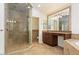 Bathroom features a glass-enclosed shower, wood vanity with granite countertop, mirror, and tile flooring at 1216 E Rocky Slope Dr, Phoenix, AZ 85048