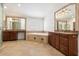 Bathroom with dual sinks, wood cabinets, granite countertops, a bathtub and tile floors at 1216 E Rocky Slope Dr, Phoenix, AZ 85048