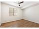 Simple, empty bedroom featuring hardwood floors and natural light from the window at 1216 E Rocky Slope Dr, Phoenix, AZ 85048