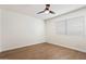Bright bedroom with hardwood floors, ceiling fan, and a large window providing natural light at 1216 E Rocky Slope Dr, Phoenix, AZ 85048