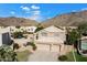 Two-story home featuring a three car garage, green lawn, and mountain views at 1216 E Rocky Slope Dr, Phoenix, AZ 85048