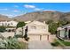 Charming two-story home boasts a three car garage, tile roof and is nestled against a scenic mountain backdrop at 1216 E Rocky Slope Dr, Phoenix, AZ 85048
