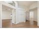 Hallway features hardwood floors, white walls, and multiple doors leading to other rooms at 1216 E Rocky Slope Dr, Phoenix, AZ 85048