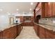 Spacious kitchen boasts custom wood cabinets, granite countertops, and stainless steel appliances at 1216 E Rocky Slope Dr, Phoenix, AZ 85048