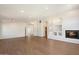 Living room with hardwood floors, white walls, recessed lights, a fan and a fireplace at 1216 E Rocky Slope Dr, Phoenix, AZ 85048