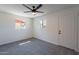 Bright bedroom with modern ceiling fan, plush carpet, and two windows at 1466 E Nielson Ave, Mesa, AZ 85204