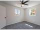 Bright bedroom featuring modern ceiling fan, plush carpet, and two windows at 1466 E Nielson Ave, Mesa, AZ 85204