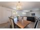 Open dining room area with modern chandelier, wood table, and views into the bright living space at 1466 E Nielson Ave, Mesa, AZ 85204