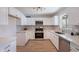 Modern kitchen featuring white cabinets, stainless steel appliances, and stylish countertops at 1466 E Nielson Ave, Mesa, AZ 85204