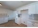 Bright kitchen featuring white cabinets, light countertops, and modern finishes, complete with stainless steel appliances at 1466 E Nielson Ave, Mesa, AZ 85204