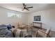 Inviting living room featuring neutral furniture, a ceiling fan, and a view from the window at 1466 E Nielson Ave, Mesa, AZ 85204