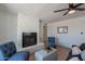 Charming living room with a decorative stone fireplace and stylish, comfortable seating at 1466 E Nielson Ave, Mesa, AZ 85204