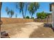 A fully fenced backyard offering ample space and a stone patio at 14936 W Maui Ln, Surprise, AZ 85379