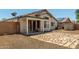 This backyard features a covered patio and sliding glass doors for indoor/outdoor flow at 14936 W Maui Ln, Surprise, AZ 85379