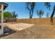 Spacious backyard featuring a stone patio and a block wall for privacy at 14936 W Maui Ln, Surprise, AZ 85379