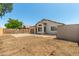 A spacious backyard featuring a block wall, storage shed, and covered patio area at 14936 W Maui Ln, Surprise, AZ 85379