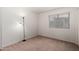 This bedroom boasts a floor lamp and a window with blinds, providing ample lighting and privacy at 14936 W Maui Ln, Surprise, AZ 85379