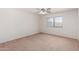 Well lit carpeted bedroom with ceiling fan and a window at 14936 W Maui Ln, Surprise, AZ 85379